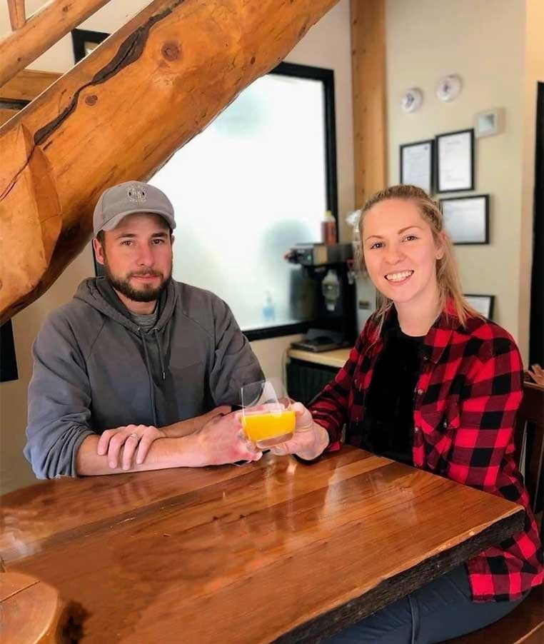 Young couple sitting at a rustic dining table